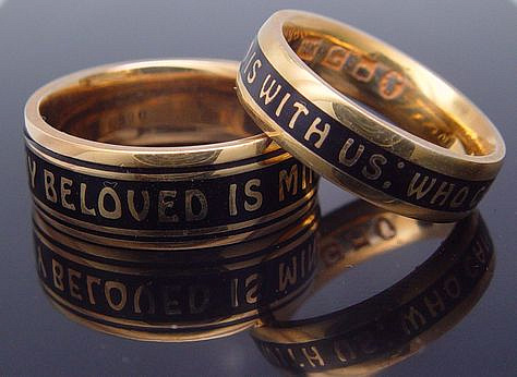 Two 18K gold wedding bands with black enamel