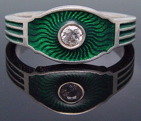 Silver ring with green enamel and gem.