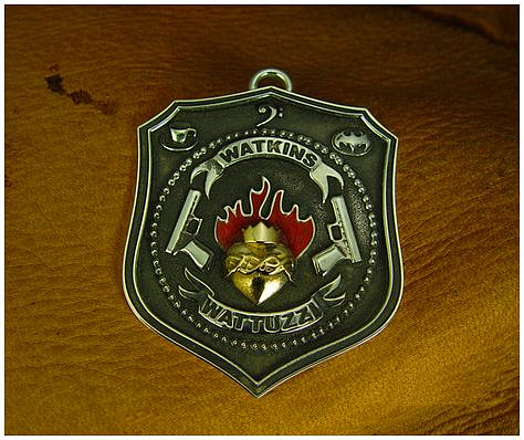 Personal silver and gold badge with red enamel.