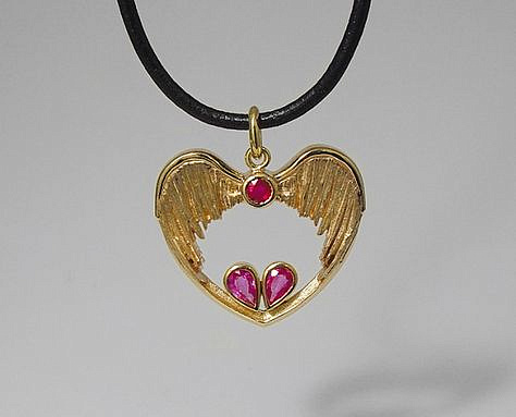 14K gold heart shape and wings charm with rubies.