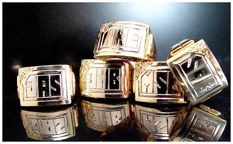 Hand engraving. Block style monograms on gold signet rings.